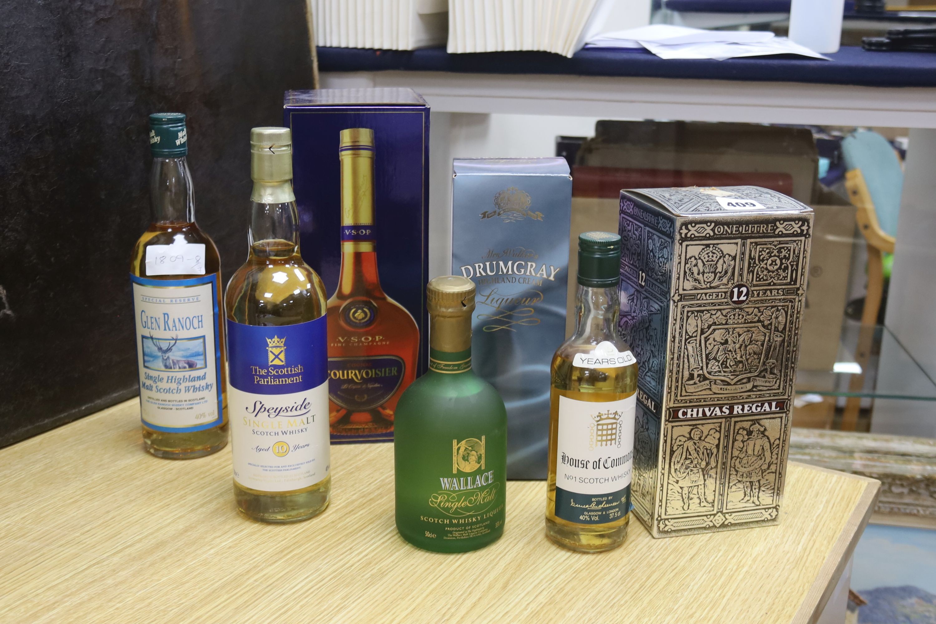 A bottle of Glen Rannoch Special Reserve, House of Commons 12 year old, Wallace, Drumgray Cream Liqueur, Courvoisier VSOP, Chivas Regal 12 Year Old, Scottish Speyside Single Malt (7 bottles)